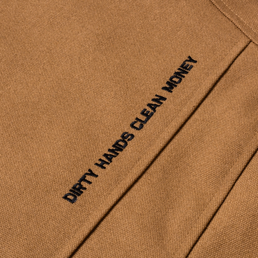 Detail shot of Dirty Hands Clean Money embroidery on the Toro Insulated Canvas Jacket