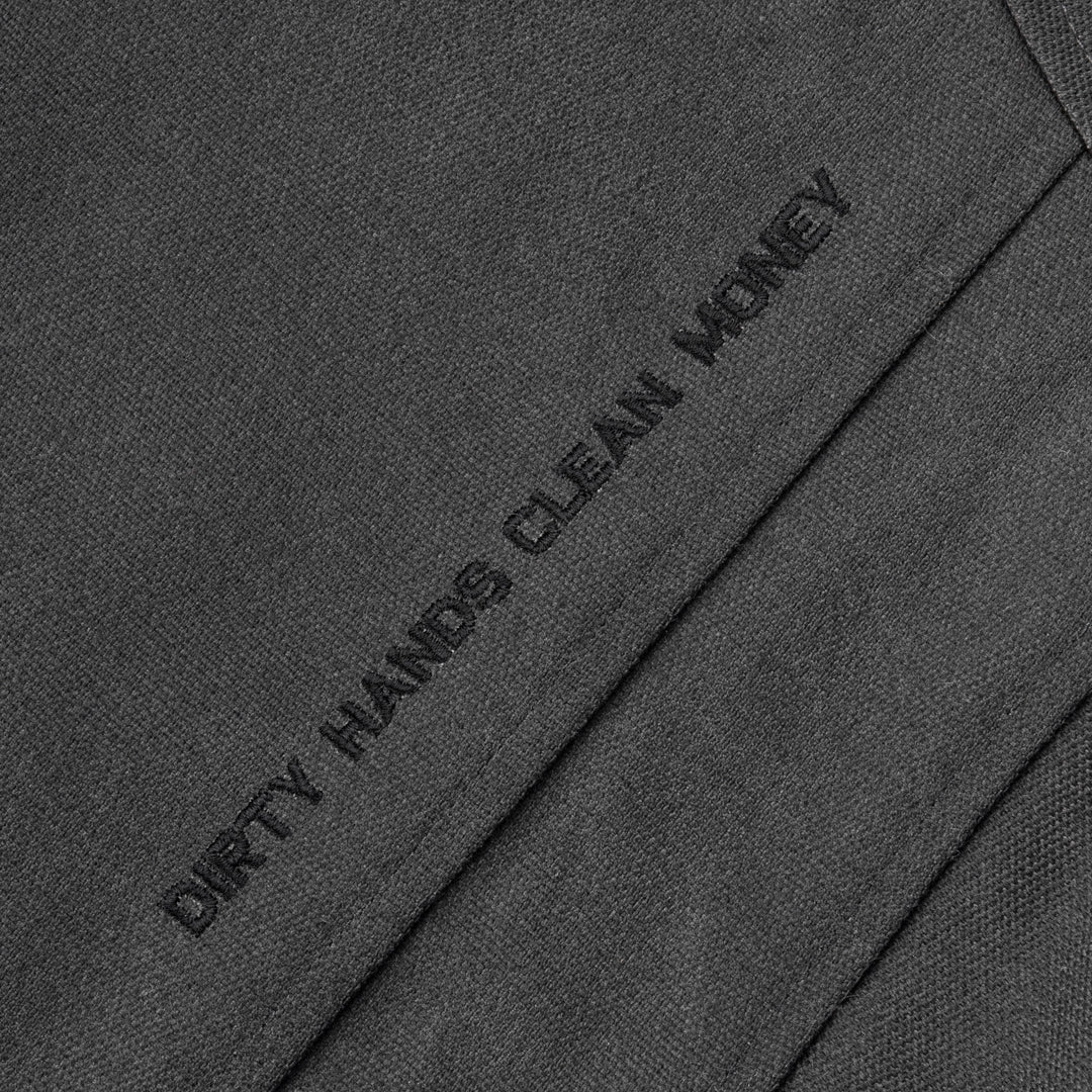 Detail shot of Dirty Hands Clean Money embroidery on the Toro Insulated Canvas Jacket